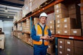 Smiling portrait of a male warehouse worker holding digital tablet in hand looking at camera Royalty Free Stock Photo