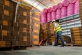 A male warehouse worker pulling a pallet truck. Cardboard boxes on a pallet in warehouse Royalty Free Stock Photo