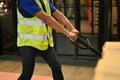 Male warehouse worker pulling the pallet truck with parcel boxes, working in warehouse. cropped Royalty Free Stock Photo