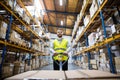 Male warehouse worker pulling a pallet truck. Royalty Free Stock Photo