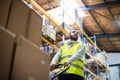 Male warehouse worker pulling a pallet truck. Royalty Free Stock Photo