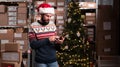 Male warehouse worker working at christmas time using digital tablet to inventory warehouse Royalty Free Stock Photo