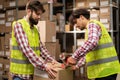 Male warehouse workers sealing cardboard boxes in distribution centre. Royalty Free Stock Photo