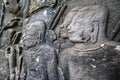 Male warriors with large earlobes carving on the facade of Angkor Thom Bayon, Angkor. Cambodia Royalty Free Stock Photo
