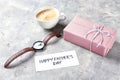 Male watch with cup of coffee and gift box for Father's Day on grey textured background Royalty Free Stock Photo