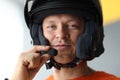 Male wearing helmet with microphone for hands free connection, interphone for motorcyclists