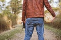 Male wearing a leather jacket holding a desk globe and the bible with a blurred background Royalty Free Stock Photo