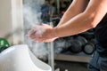 Male weightlifter processes hands talcum powder