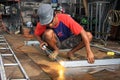 Male welder/fabricator welding metalwork in workshop