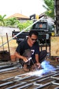 Male welder/fabricator welding metalwork in workshop