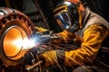 A male welder makes welding of metal parts. Royalty Free Stock Photo