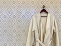 Male white bathrobe hanging on a hanger Royalty Free Stock Photo