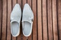 Male white shoes over the wooden table Royalty Free Stock Photo