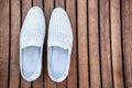 Male white shoes over the wooden table Royalty Free Stock Photo