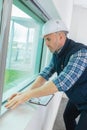 Male window fitter working indoors
