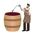 Male winemaker checks wine during fermentation process in large wooden vat. Winemaking, maceration, fermentation Royalty Free Stock Photo