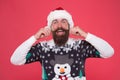 Male winter hair care and fashion. happy new year. merry christmas. cheerful bearded man in santa hat and sweater Royalty Free Stock Photo