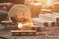 Male woker cutting metal using angle circular saw.