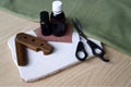 Male wooden comb, care oils and scissors for haircuts on white desk