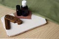 Male wooden comb, care oils on white desk