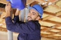 Male worker and air duct installation Royalty Free Stock Photo