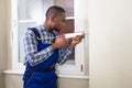 Male Worker Applying Silicone Sealant