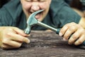 Male worker blowing a hammer on the finger