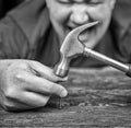 Male worker blowing a hammer on the finger