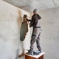 Male worker breaking wall in apartment under renovation.