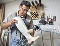 Male worker buffing prosthetic limb