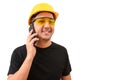 Male worker or builder in yellow helmet using smartphone isolated on white background. Construction concept Royalty Free Stock Photo