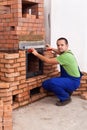 Male worker building a masonry heater Royalty Free Stock Photo