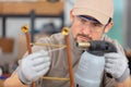 male worker building metal frame with welder