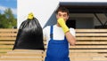 male worker or cleaner with stinky garbage bag