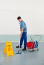 Male Worker With Cleaning Equipments Mopping Floor Royalty Free Stock Photo