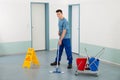 Male Worker With Cleaning Equipments Mopping Floor Royalty Free Stock Photo