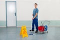 Male Worker With Cleaning Equipments Mopping Floor Royalty Free Stock Photo