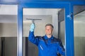 Male Worker Cleaning Glass With Squeegee Royalty Free Stock Photo