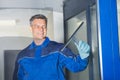 Male Worker Cleaning Glass With Squeegee Royalty Free Stock Photo