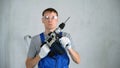 Male Worker with a Construction Drill in Hands Royalty Free Stock Photo