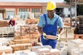 Male worker controlling quantity of ceramic tiles