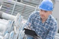 Male worker counting scaffolding poles Royalty Free Stock Photo