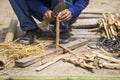 Male worker cutting bamboo wood at construction site in Thailand