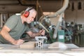 Worker cutting wood with accuracy on a sliding table saw Royalty Free Stock Photo