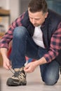 Male worker doing shoes laces up Royalty Free Stock Photo