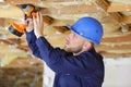 male worker drilling ceiling