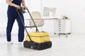 Male worker with floor cleaning machine Royalty Free Stock Photo