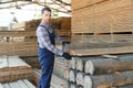Male Worker folds boards. Sawmill. Wood harvesting process