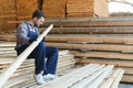 Male Worker folds boards. Sawmill. Wood harvesting process