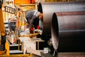 Male worker grinding butt weld pipe